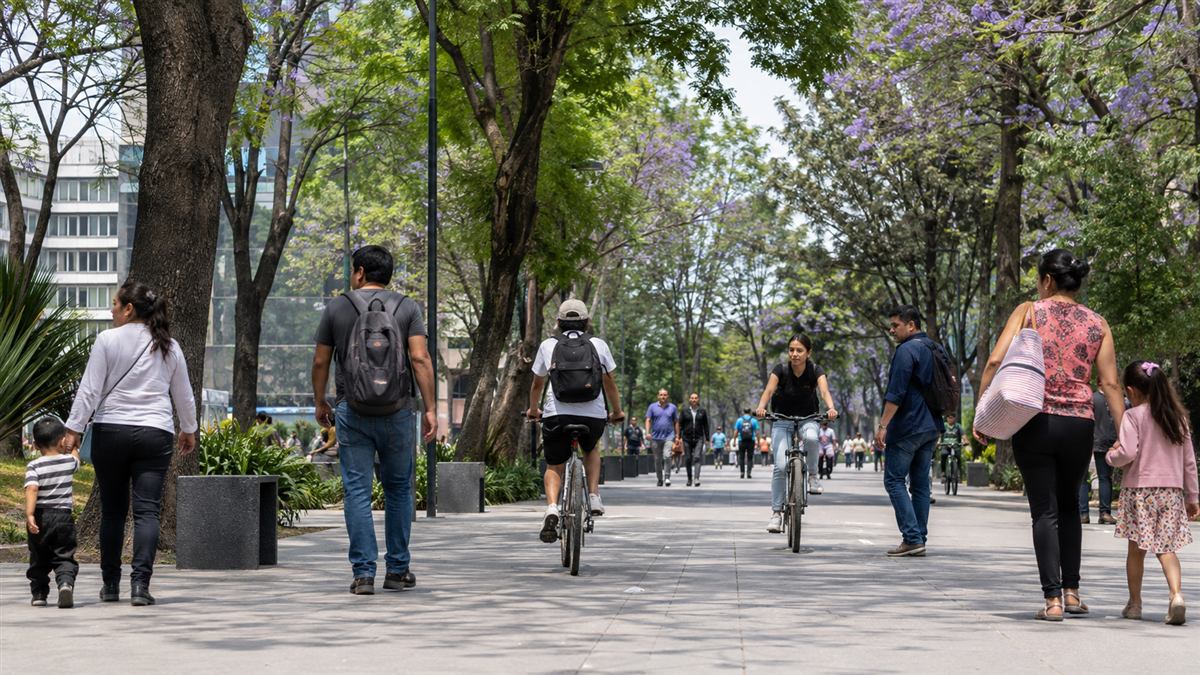 Familias y peatones comparten una plaza pública arbolada en la Ciudad de México